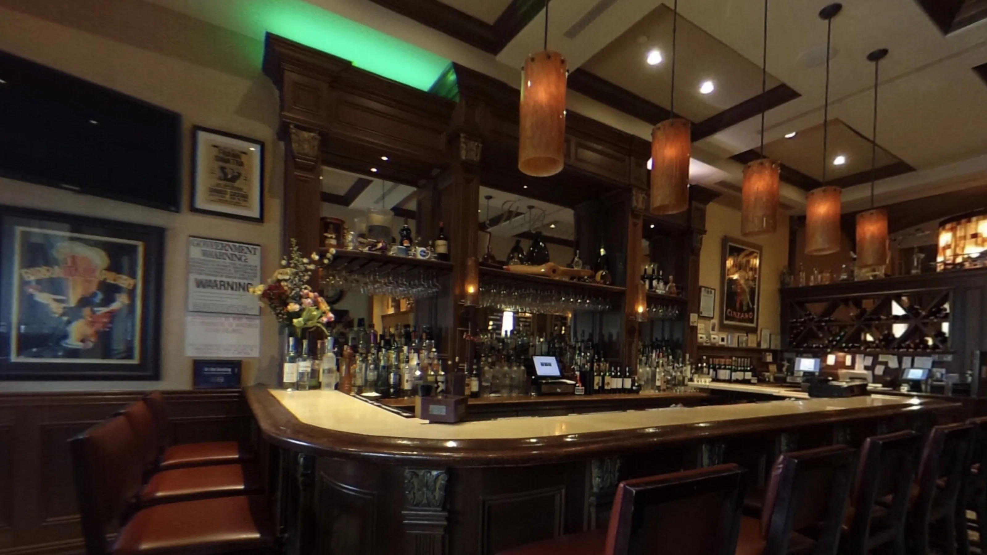 Inside Il Bacco: the bar, pendant lights, and wine racks